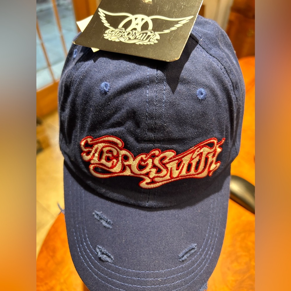 AEROSMITH HAT CAP BLUE WHITE & RED TRIM SCRIPT VINTAGE DESIGN 100% COTTON. NEW